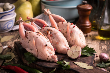 Fresh organic quails on vintage wooden table, healthy food