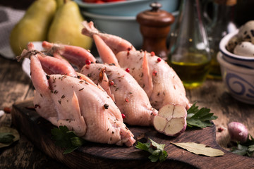 Fresh organic quails on vintage wooden table, healthy food