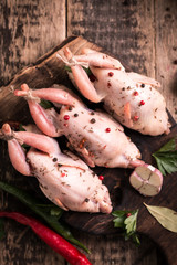 Fresh organic quails on vintage wooden table, healthy food