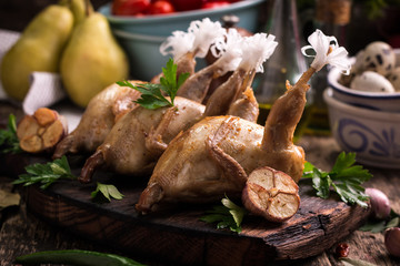 Fresh organic quails on vintage wooden table, healthy food