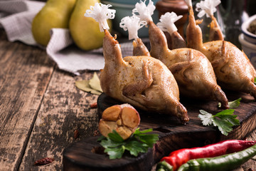 Fresh organic quails on vintage wooden table, healthy food
