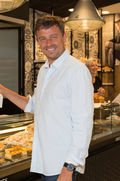 Man buying some cookies and cakes in a pastry shop