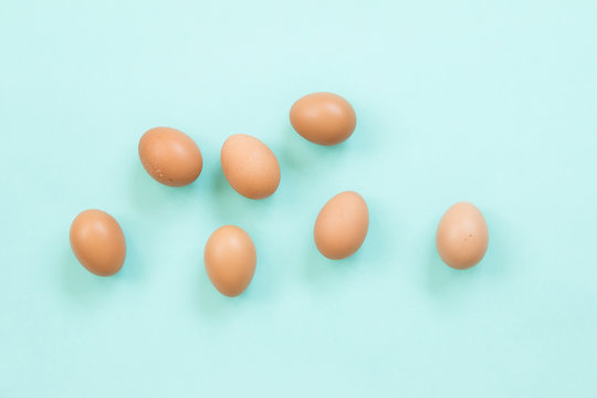 Chicken eggs on blue background.
