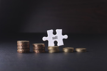 White missing puzzle and gold coins with audit  word ,copyspace