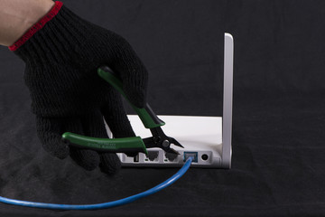 Hand cutting internet cable of router, communication concept