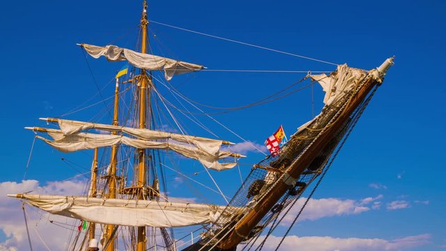 Clouds over the Masts of Sailing Ship. Time Lapse. 4K.