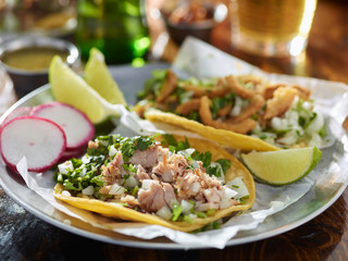 tasty tacos in yellow tortilla with chopped pork