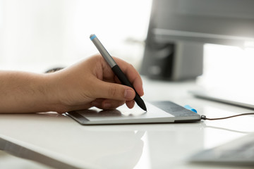 Fototapeta premium Closeup of professional designer using graphic tablet at work