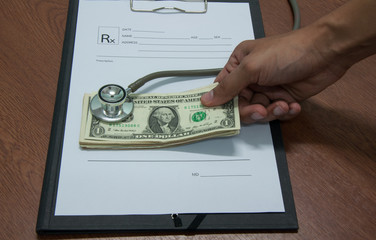 Stethoscope and money symbol for health care costs