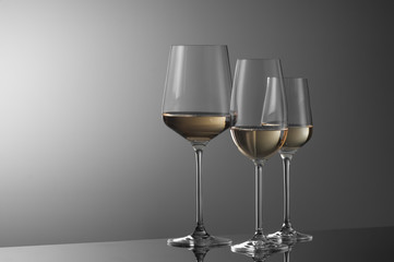 a few glasses of wine on a light background