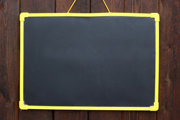 Chalk board hanging on wooden background