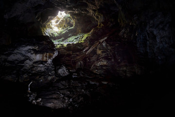 Dark karst cave in mountain, inside subterranean cave background