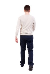 Back view of walking businessman. bearded man in a white warm sweater goes away.