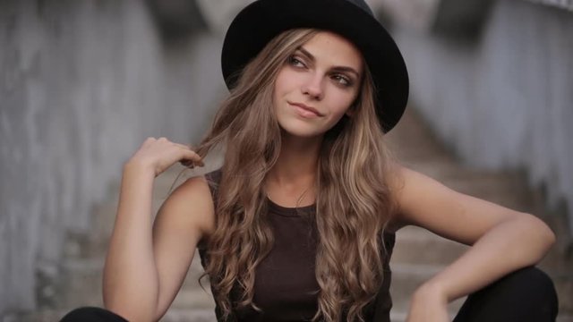 Happy young pretty girl in black hat
