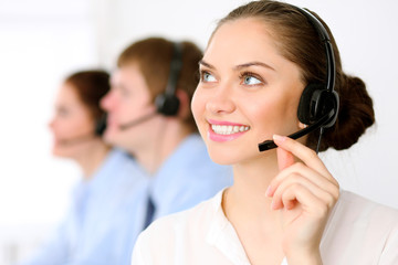 Call center operators. Young beautiful business woman in headset.