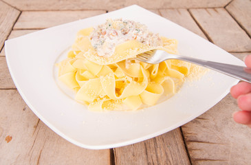 Pappardelle with chanterelle and creame being eaten with a fork