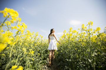 Fototapeta premium Young woman in the spring field