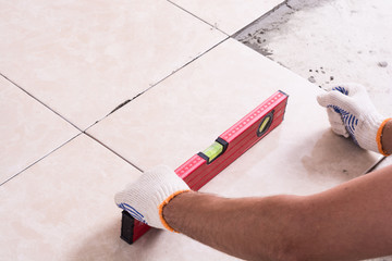 Tiler installing ceramic tiles