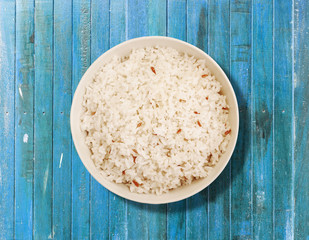 Rice in white bowl on vintage table