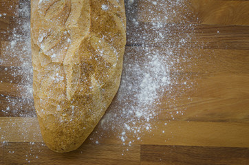 Rustic bread on old vintage planked wood table.