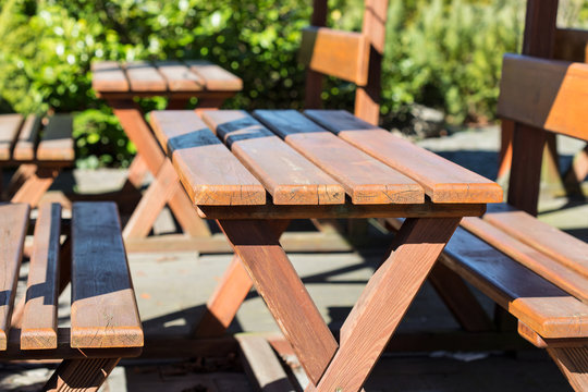 Wooden tables with benches; summer open air cafe terrace