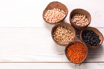 Bowls of various legumes on wooden background,healthy food,vegan food.