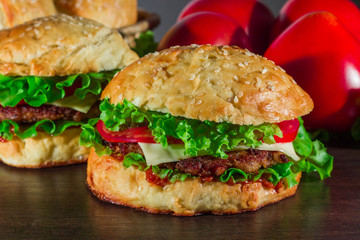 Close-up of home made tasty burgers on wooden table