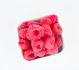 Raspberries: a bowl of fruit on white background