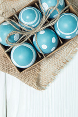 Fototapeta na wymiar Easter concept with colored eggs on wooden background