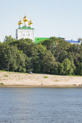 White church on the bank of a wide river