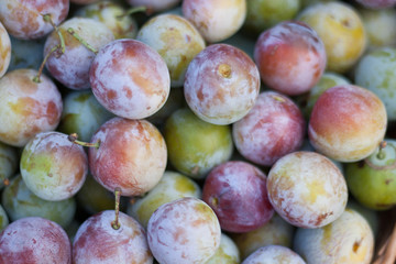 ripe plums as a background on the market