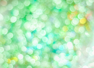 Blurred background with bokeh lights in green pastel colours
