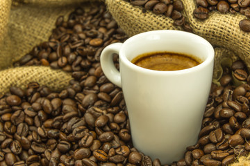 fresh espresso and strewn mediumly roasted coffee beans