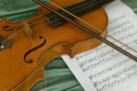 violin, bow and music sheet 