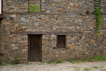 Fototapeta na wymiar Windows and door in one old Bulgarian house in Kovachevitsa village, Bulgaria