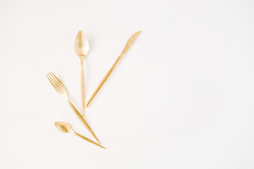 golden fork, spoon, knife isolated on white. flat lay, top view