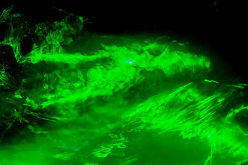 Obraz na płótnie Canvas Abstract Green Light / Blurred patterns of green light on black.