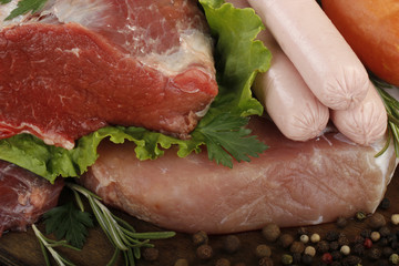 meat with spices on wooden background