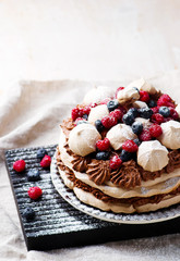 meringue cake with chocolate mousse and berries