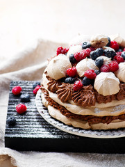 meringue cake with chocolate mousse and berries