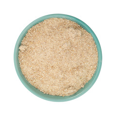 Bowl filled with stone ground whole wheat muffin mix on a white background.
