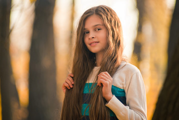 Portrait of pretty girl on the background  yellow leaves