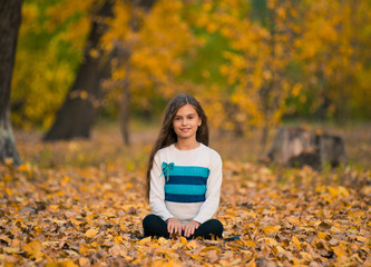 portrait of a beautiful smiling teenage in autumn