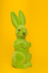 Green decoration easter bunny on a yellow background