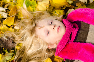 Naklejka na ściany i meble lovely child in autumn leaves