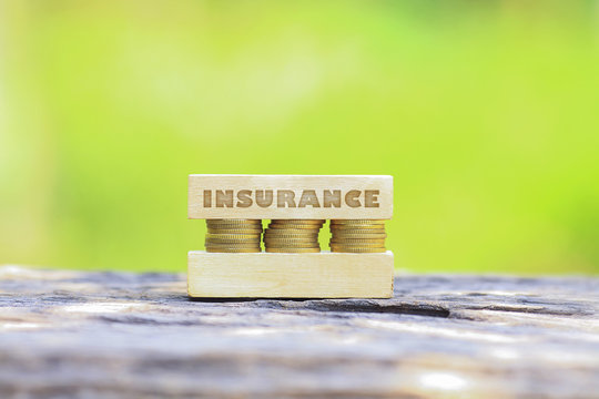 Business Concept - INSURANCE WORD, Golden coin stacked with wood