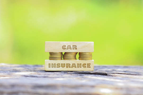 Business Concept - CAR INSURANCE WORD, Golden coin stacked with woooden bar
