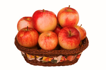 Ripe red apples in wicker basket isolated on white