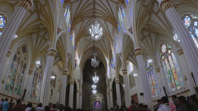 LAS LAJAS, COLOMBIA - CIRCA SEPTEMBER 2015: People on mass inside  the majestic Sanctuary builded over a canyon during the anniversary of the virgin of las lajas. 4k