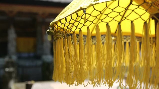 Traditions umbrella on the island of Bali Indonesia. Yellow Traditions Umbrella in Gunung Kawi Is An 11Th Century Temple Complex In Tampaksiring North East Of Ubud, Bali Indonesia